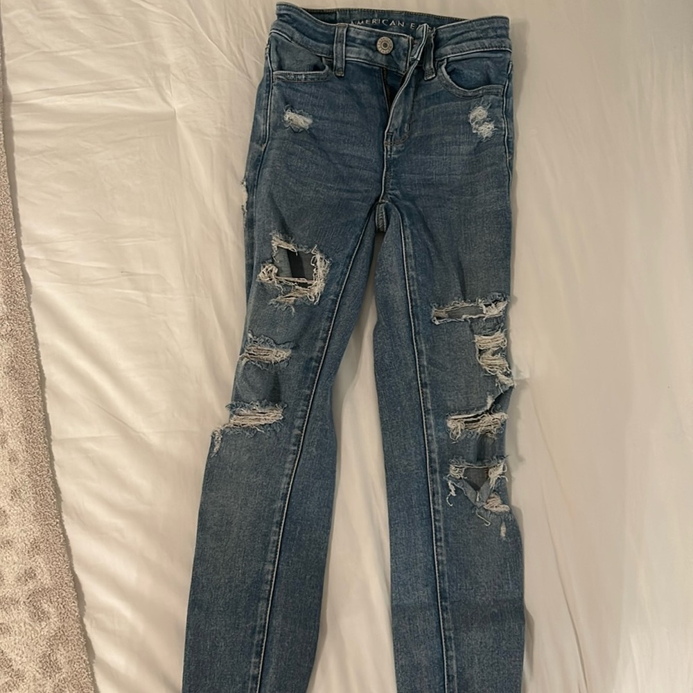 Denim,distressed and ripped American Eagle skinny jeans, well worn, soo cute on!